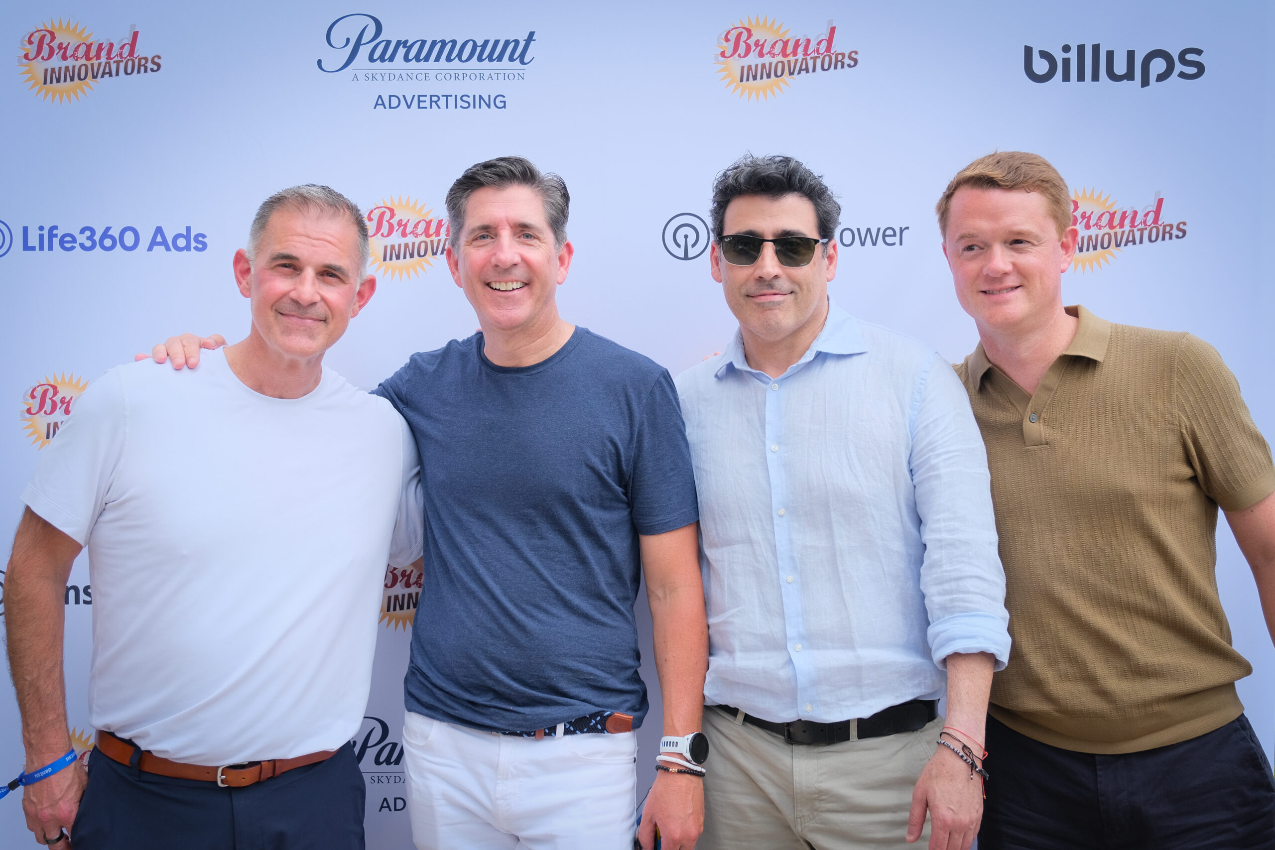 Four attendees pose in front of Brand Innovators Cannes 2026 backdrop.